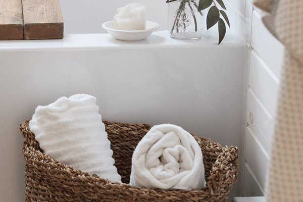 https://www.bathfitter.com/wp-content/uploads/2022/08/wicker-basket-white-towels-bathroom-1.png